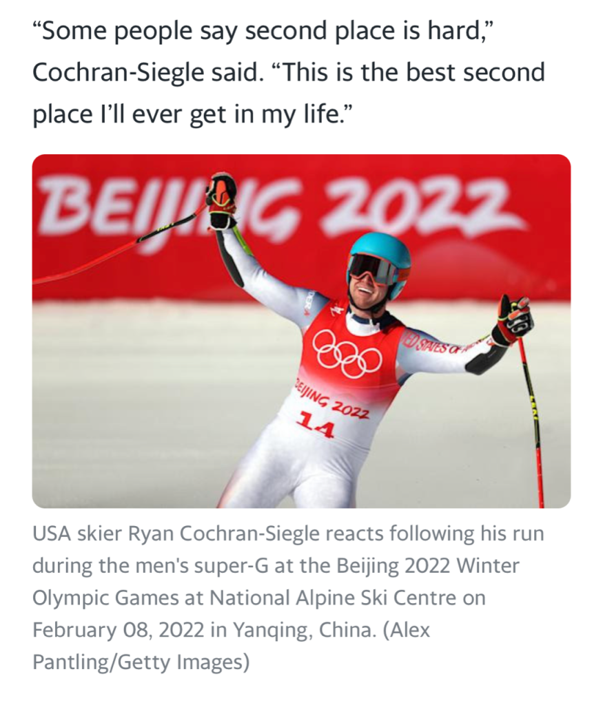 Ryan Cochran Siegle with arms raised - wins silver at Olympics